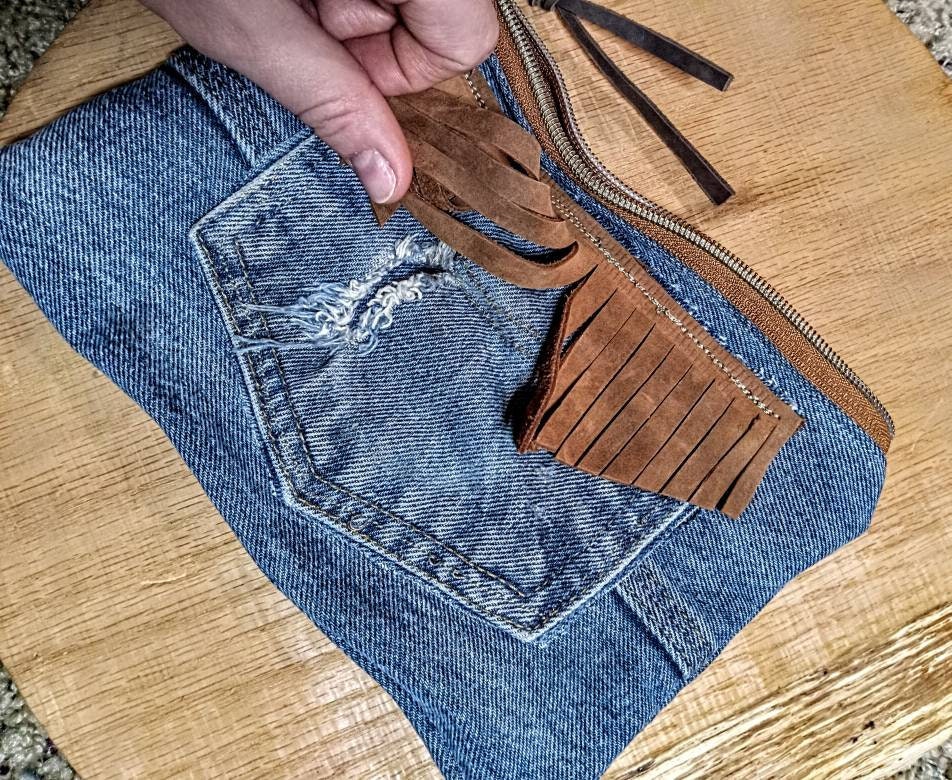 Denim and leather tassle, chew can ring zip pouch.
